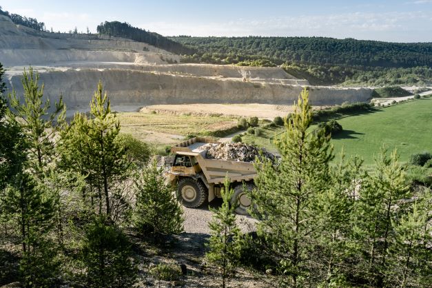 Truck carrying aggregate through quarry