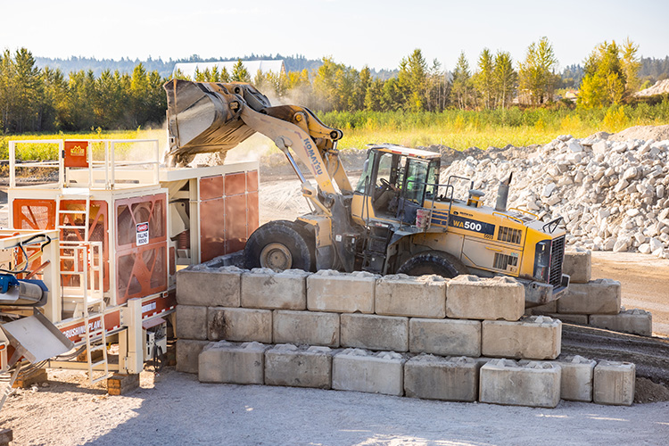 Industrial scooper truck pouring aggregates